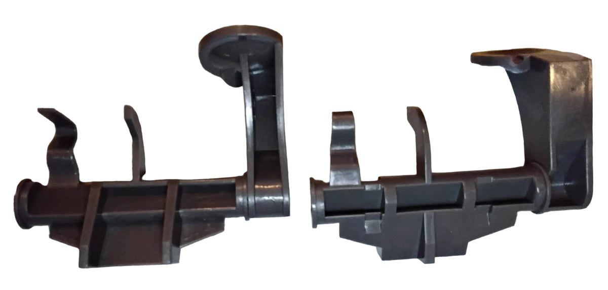 Two identical grey plastic rack adjuster thumb tabs in opposie orientations so that both sides of the part is visible. From an aftermarket substitute for a Whirlpool W10712395 Upper Rack Adjuster Kit